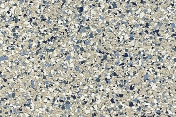 Capri Epoxy Flake Flooring Close-up view of Capri epoxy floor coating with a blend of white, beige, and various shades of blue flakes.